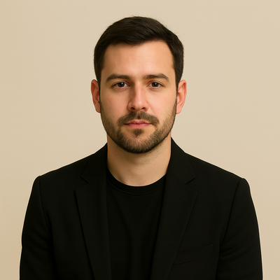 Man wearing a black blazer over a black shirt against a beige background