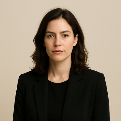 Woman wearing a black blazer against a beige background